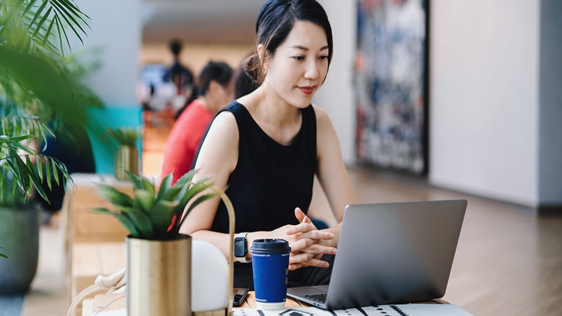 Person in an office working on a laptop